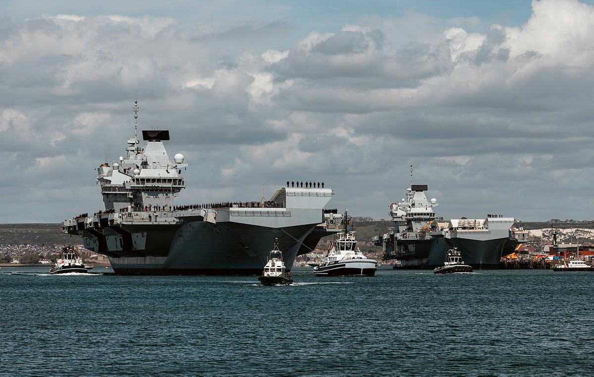 HMS Prince of Wales passes HMS Queen Elizabeth as she leaves HMNB Portsmouth, 2025. MOD © Crown copyright 2025